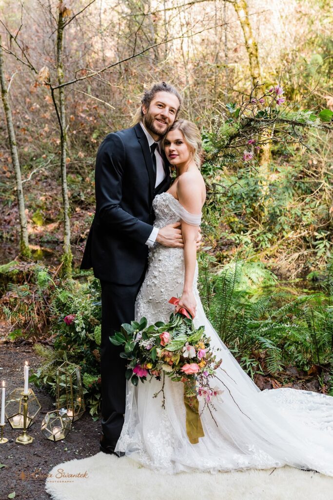 romantic bride and groom surrounded by lush forests during their Belknap Hot Springs elopement