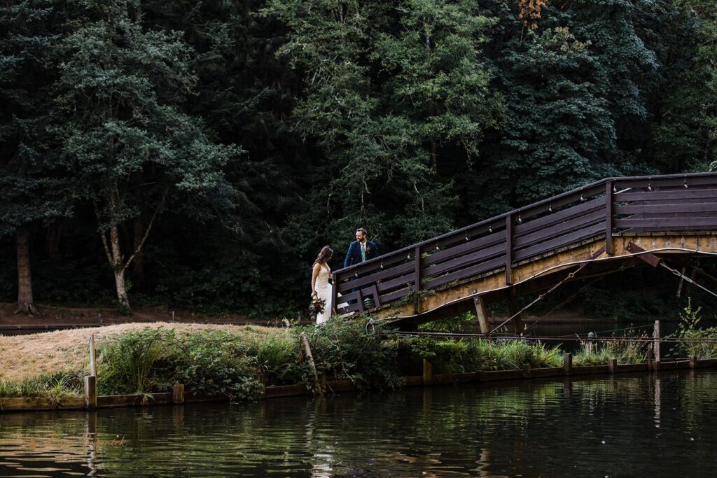 playful bride and groom roaming around lush woods during their Oregon forest elopement
