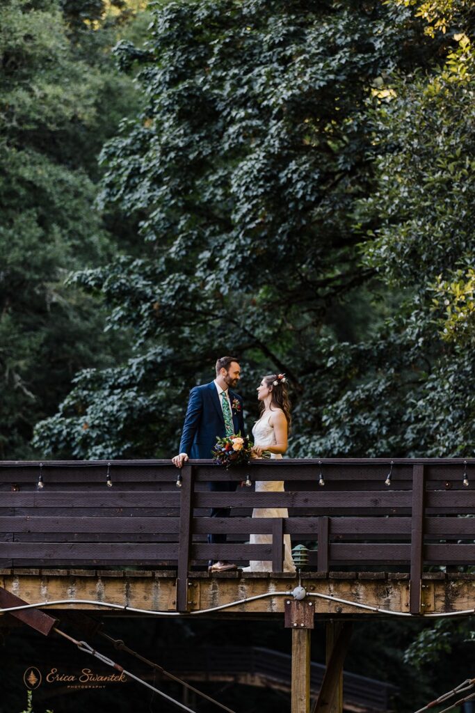 playful bride and groom roaming around lush woods during their Oregon forest elopement