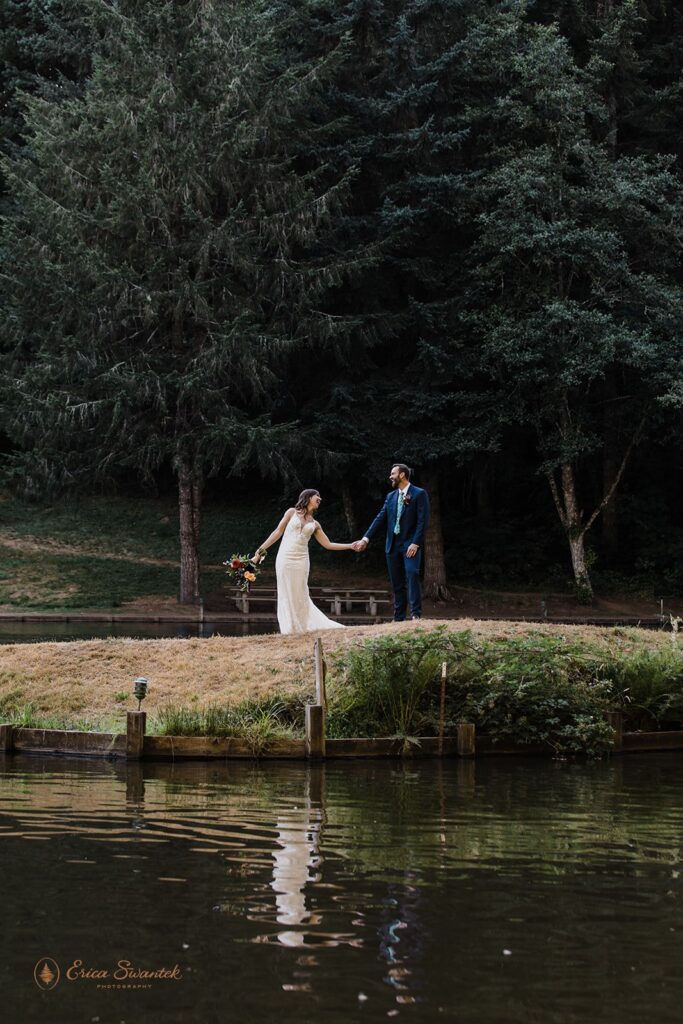playful bride and groom roaming around lush woods during their Oregon forest elopement
