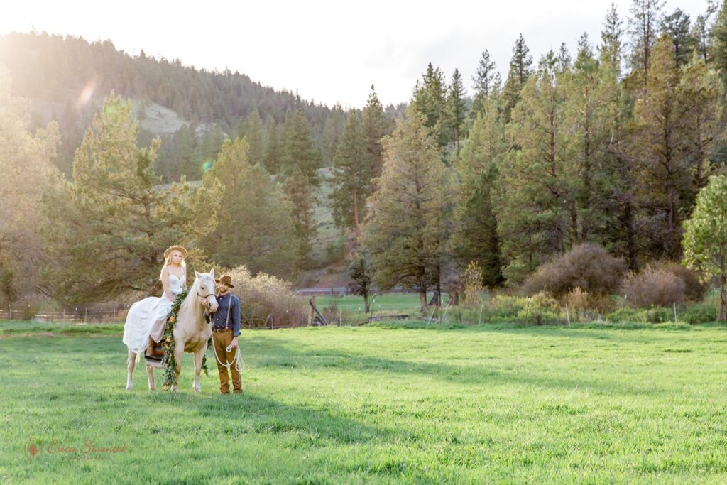 bride riding horseback while the new husband walks right next to them