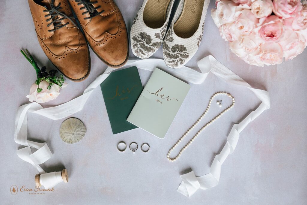 classy elopement details flatlay of shoes, vow books, jewelry