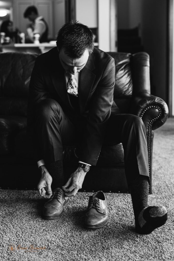 groom putting on his shoes