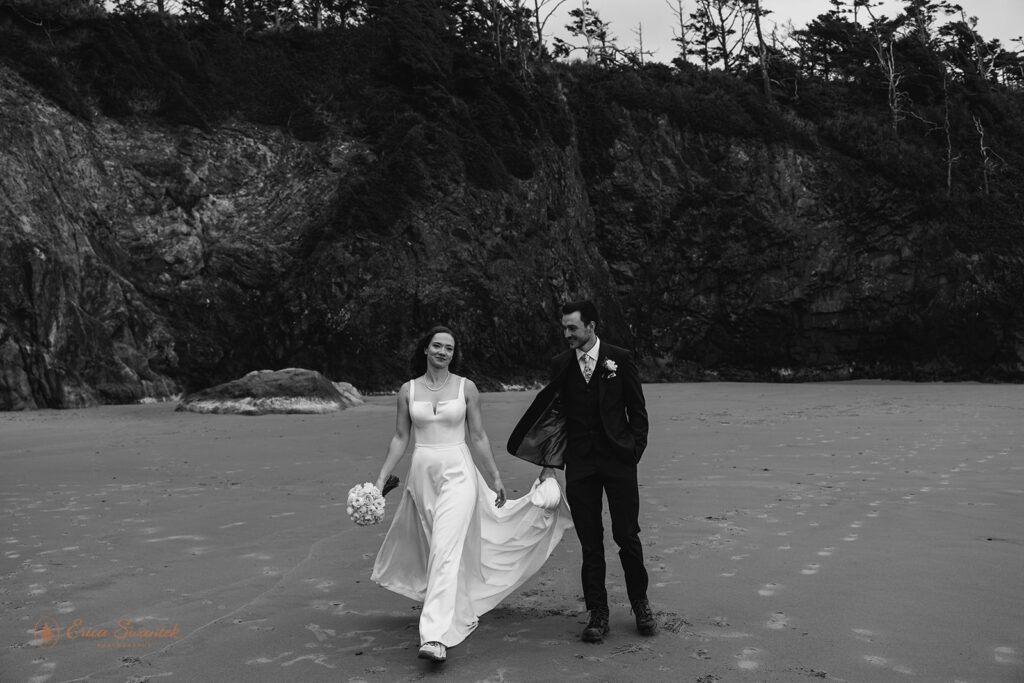 bride and groom walking along the coast in oregon