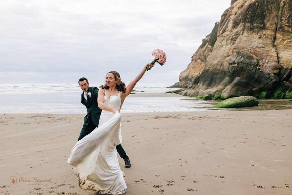 bride and groom having fun along the oregon coast