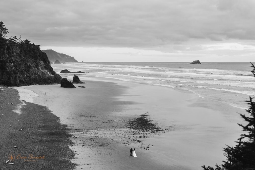 bride and groom from the distance at oregon shore