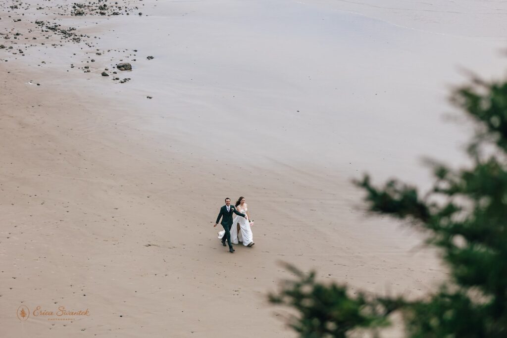 bride and groom having fun along the oregon coast