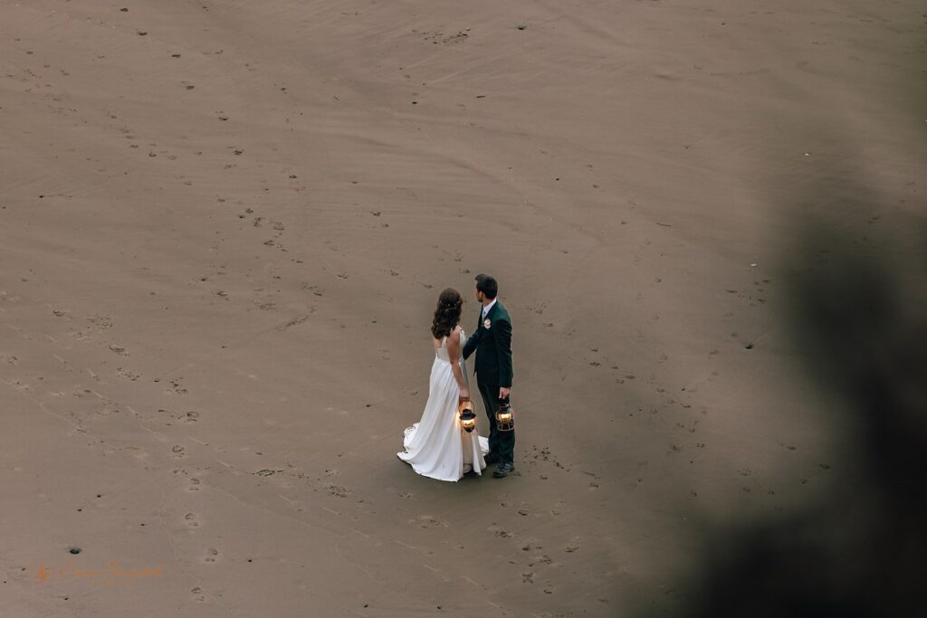 bride and groom from the distance at oregon shore