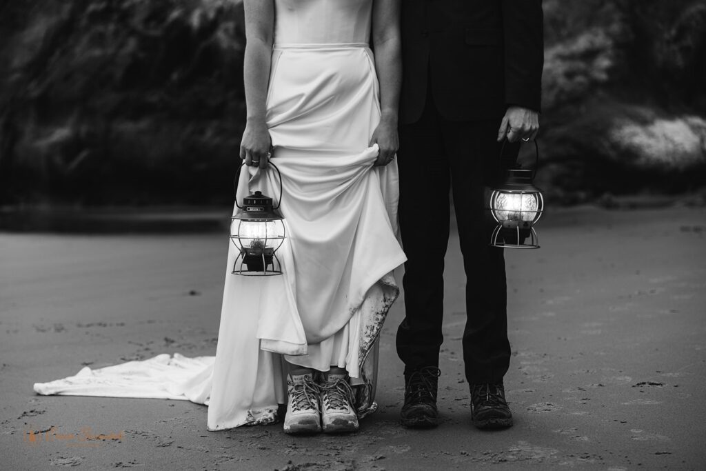 bride and groom with lanterns along oregon coast