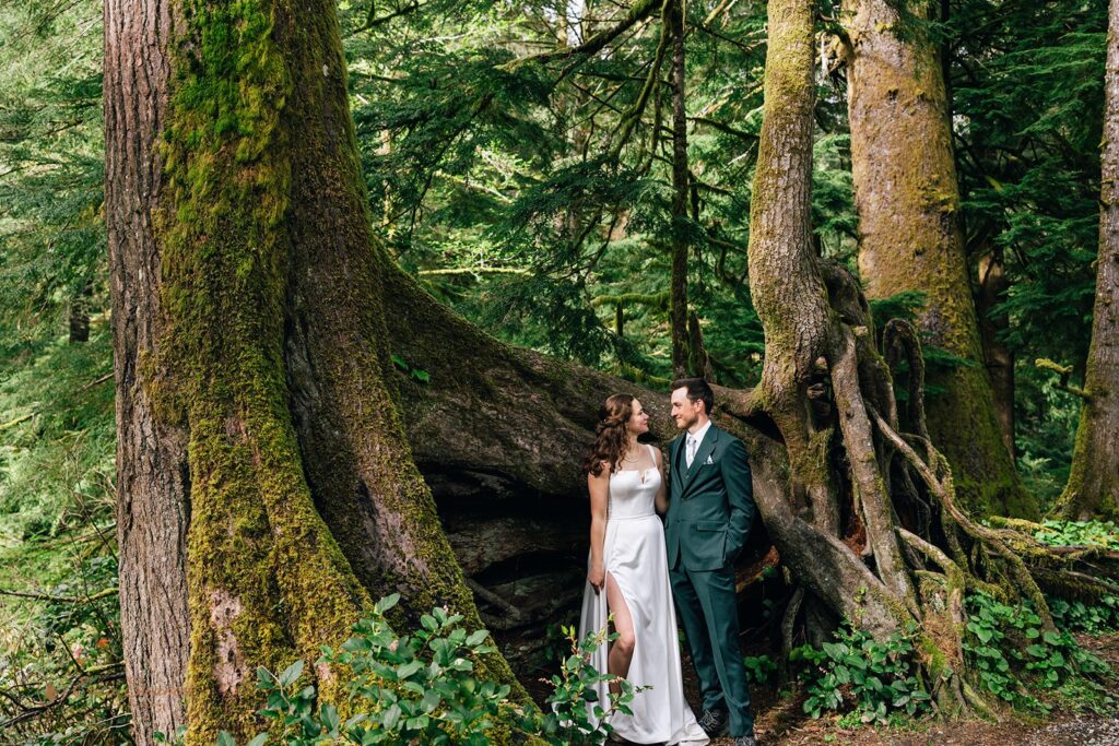 bride and groom surrounded by a lush forest