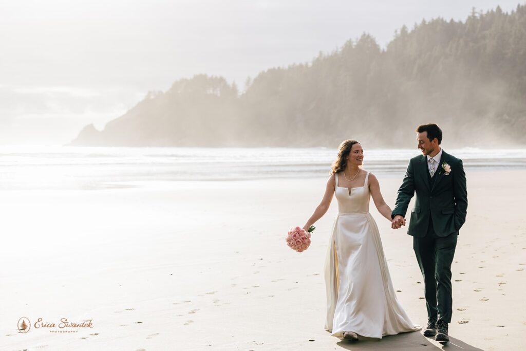 bride and groom walk along the beach coast during their dreamy oregon coast micro wedding