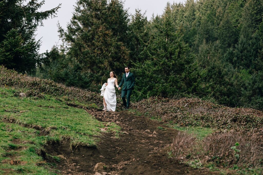 bride and groom walking the elk flats trail together during their oregon coast micro wedding day