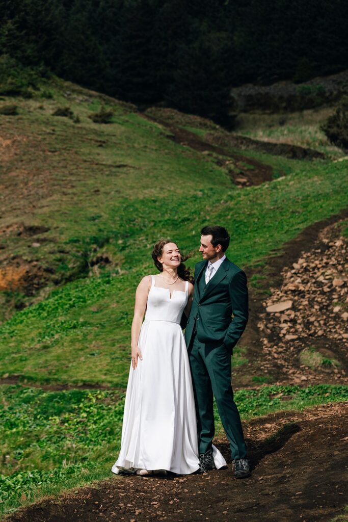 bride and groom walking the elk flats trail together during their oregon coast micro wedding day