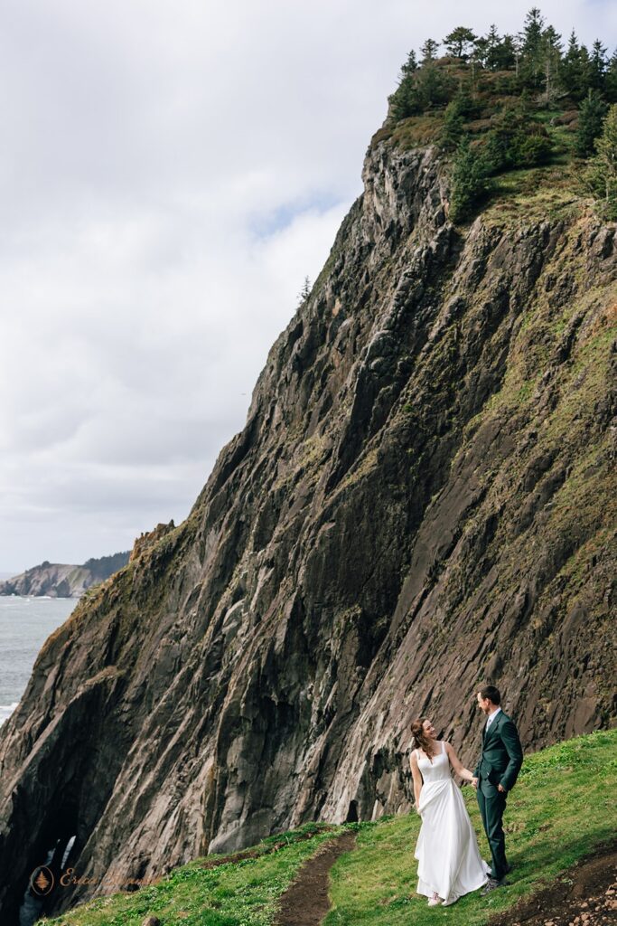 bride and groom walking the elk flats trail together during their oregon coast micro wedding day