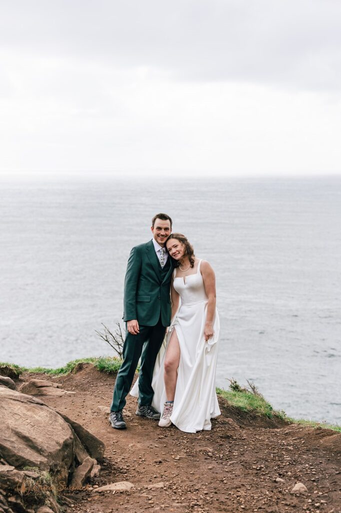 bride and groom on the cliff with ocean views during their oregon coast micro wedding