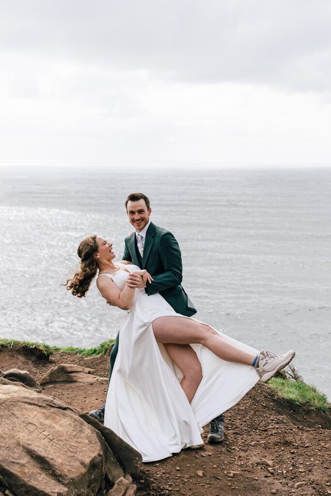 bride and groom on the cliff with ocean views during their oregon coast micro wedding