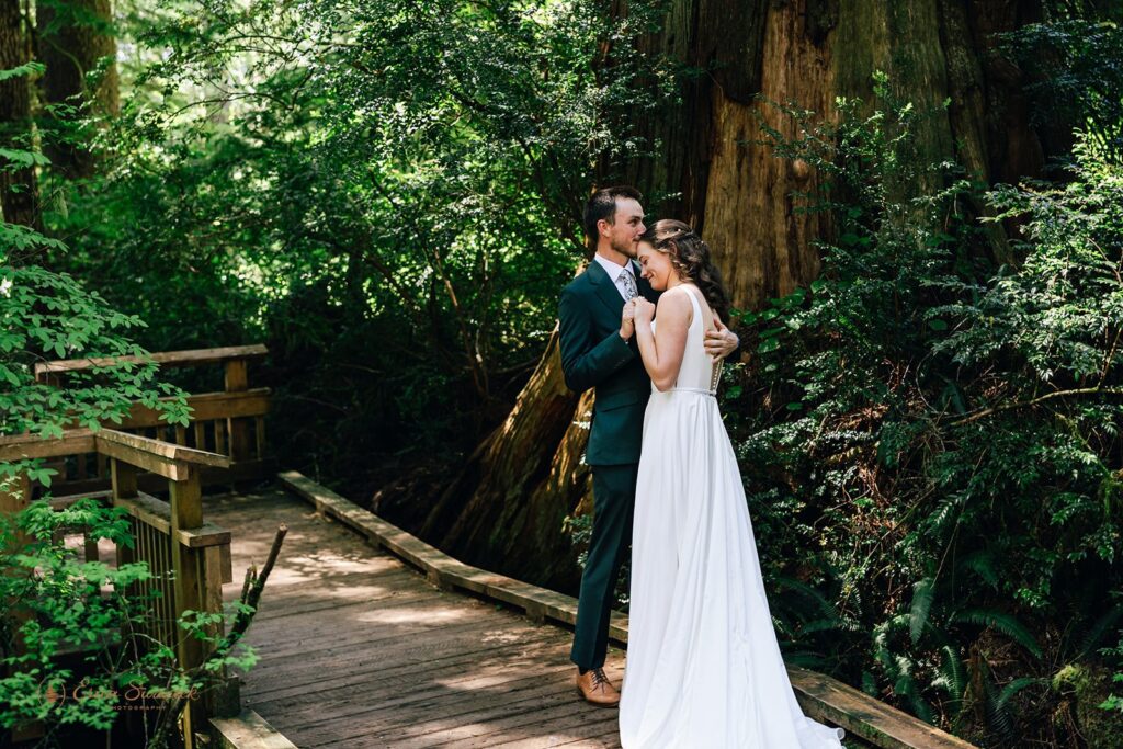 candid bride and groom first look in the forest during their oregon coast micro wedding day