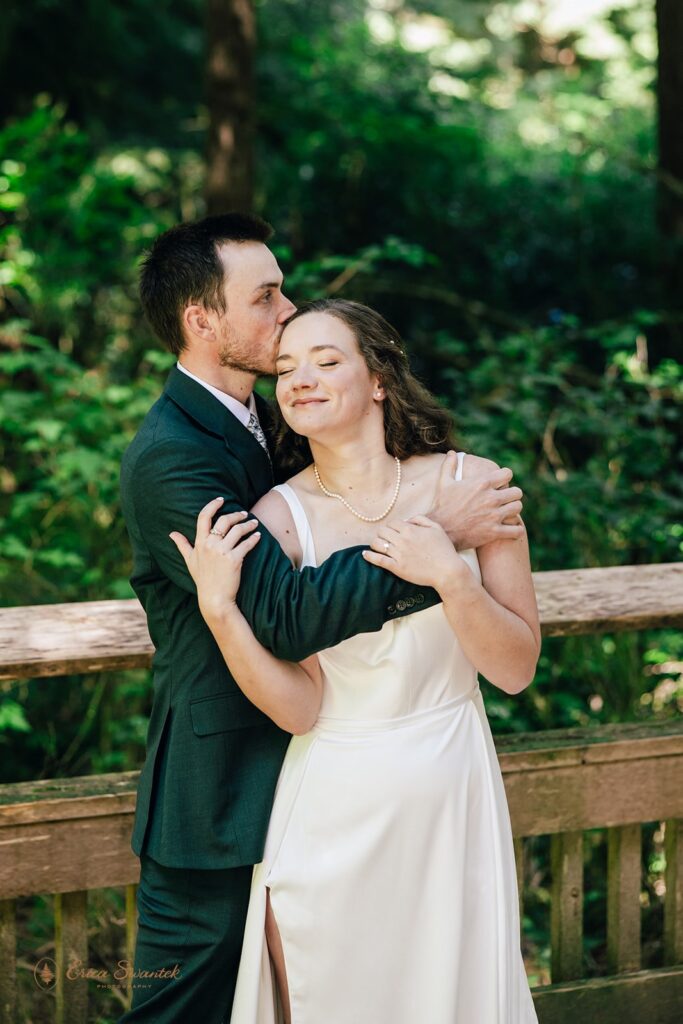 bride and groom hugging in the forest during their oregon coast micro wedding day
