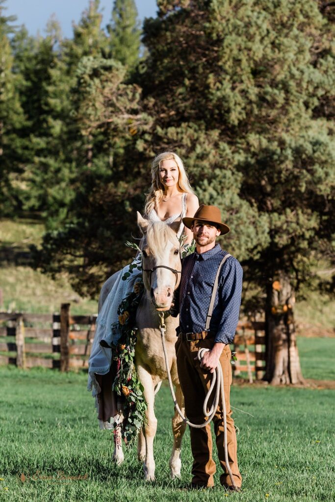 western inspired elopement with bride on horseback and groom walking alongside