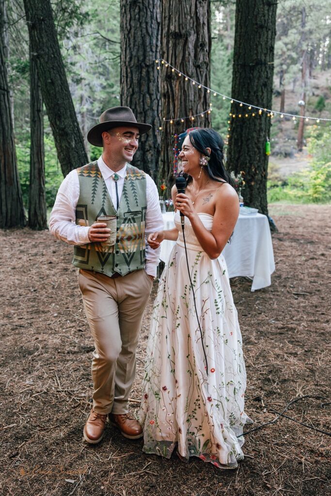 bride and groom delivering a speech during their cozy outdoor campground wedding reception