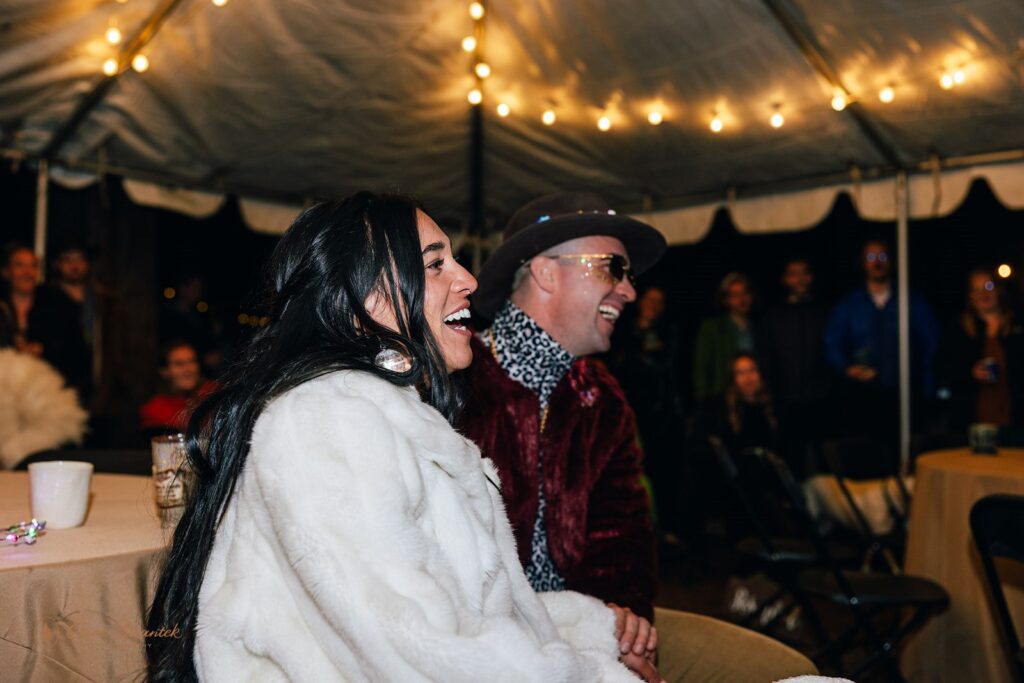 bride and groom laughing and having a good time for their wedding celebration festival