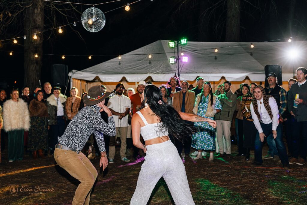bride and groom dancing together during their festival inspired outdoor wedding reception