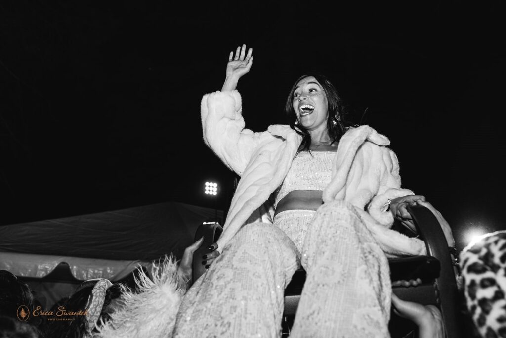 bride being thrown in the air during the wedding reception