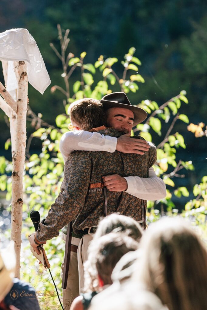 groom hugging a loved one during the wedding ceremony