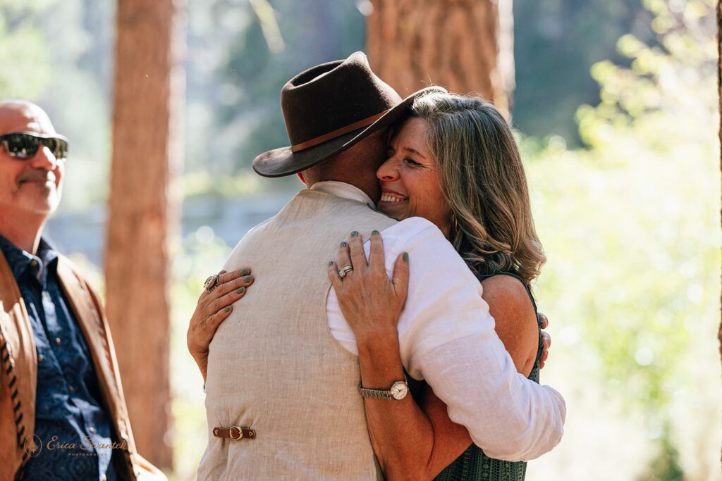 newlyweds hugging with their loved ones after ceremony