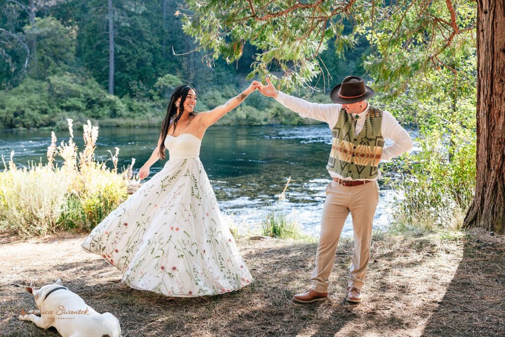 joyful newlyweds laughing and enjoying their time during their campground wedding along Metolius River