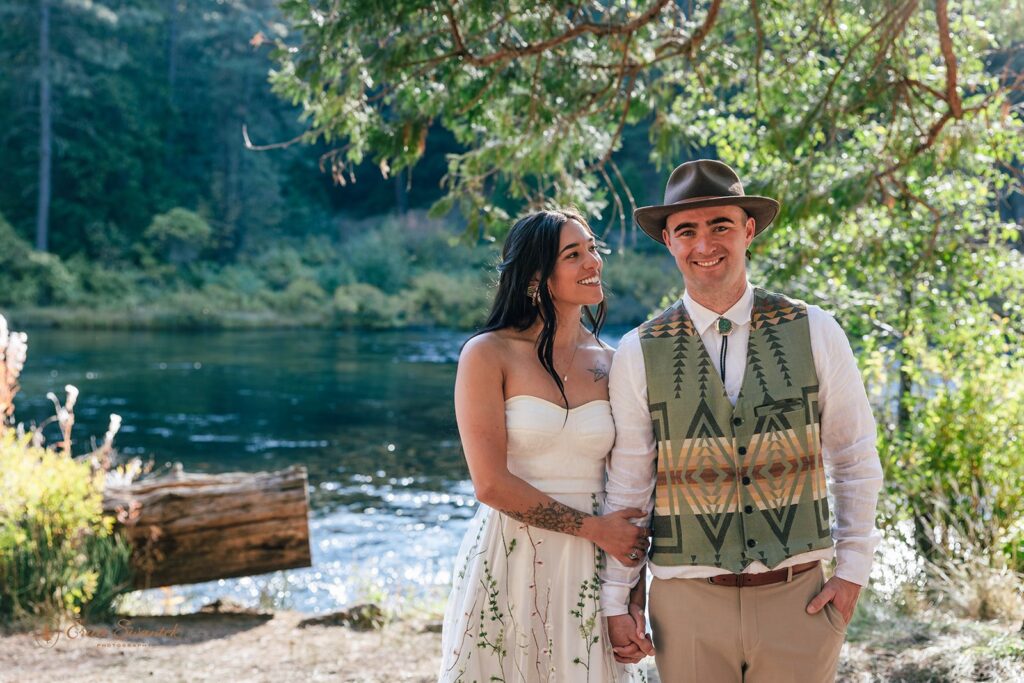joyful newlyweds laughing and enjoying their time during their campground wedding along Metolius River