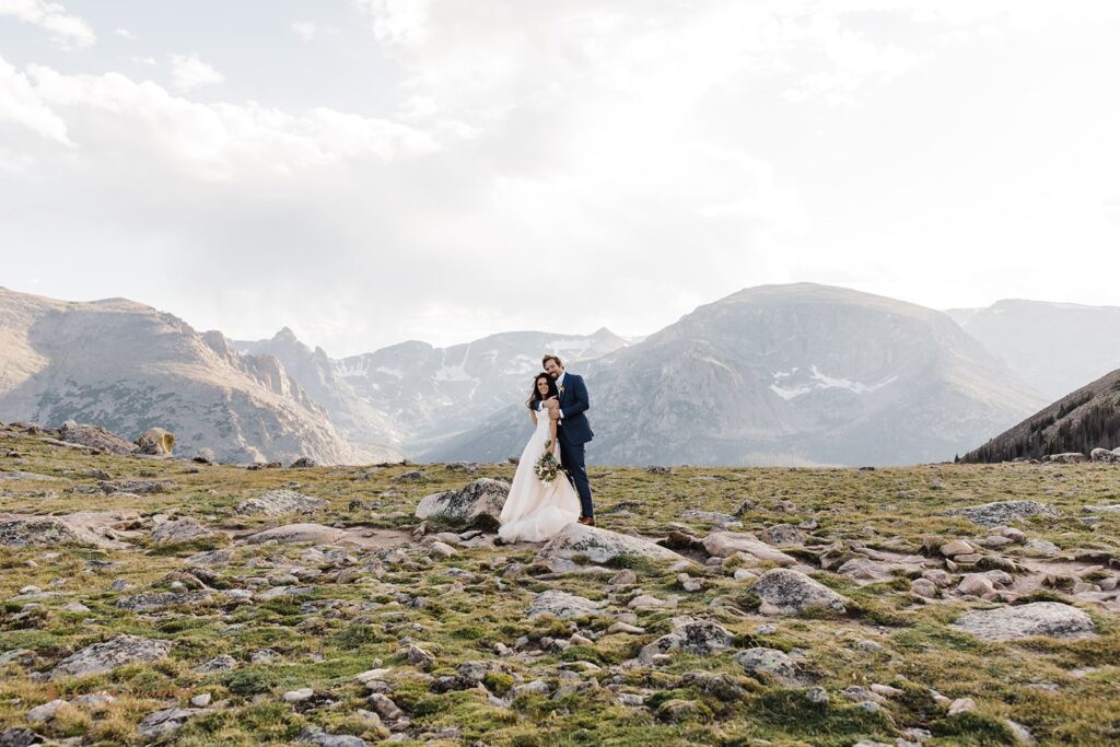 adventurous elopement couple hugging in UTE trail in RMNP