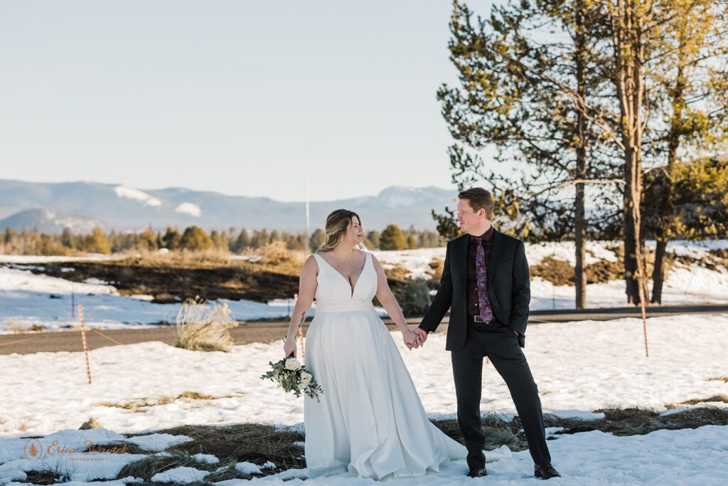 bride and groom surrounded by snowy winter landscapes in sunriver