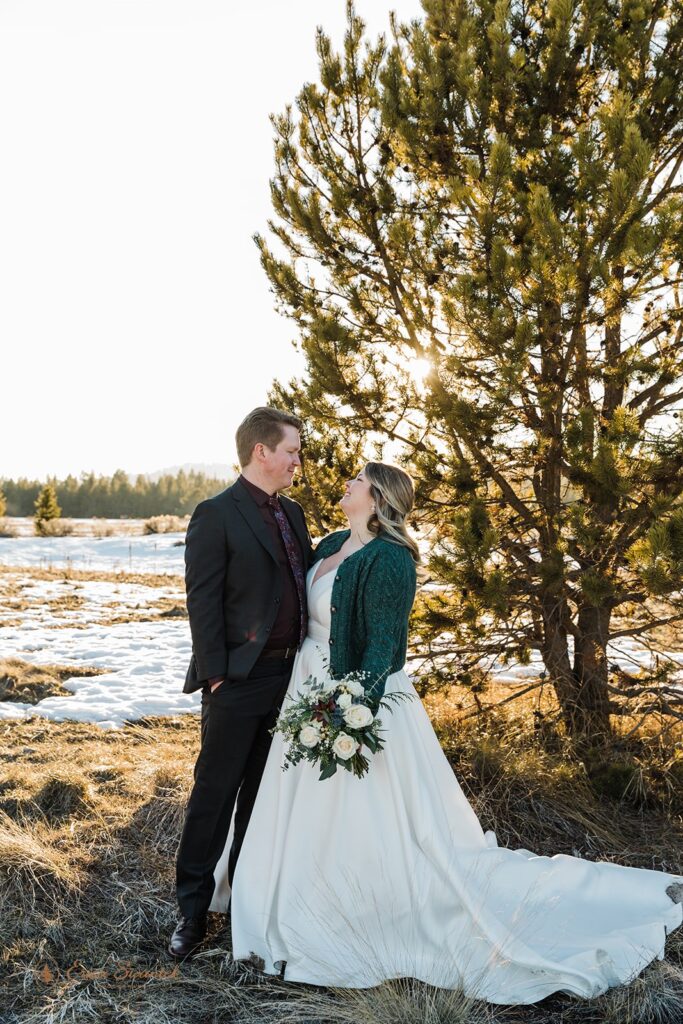 bride and groom surrounded by snowy winter landscapes in sunriver