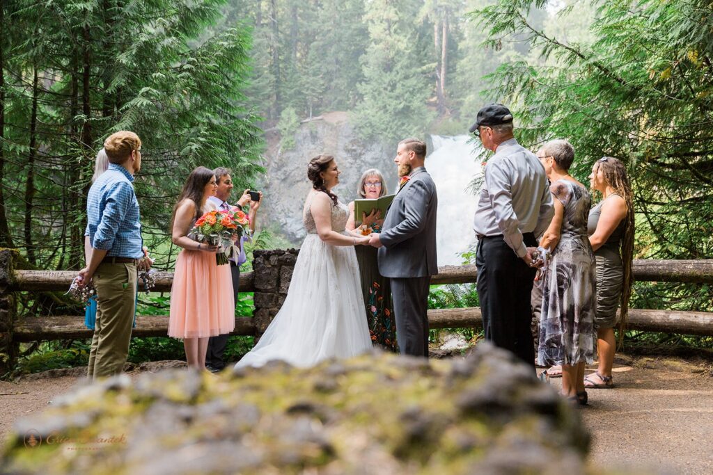 A couple gets married at Sahalie Falls on the McKenzie River in Oregon.