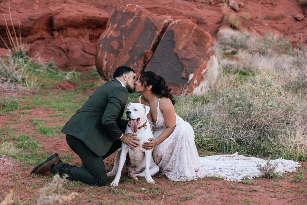 bride and groom posing with their dog