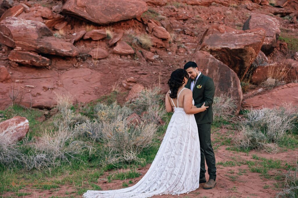 candid bride and groom first look in a red rock desert in moab