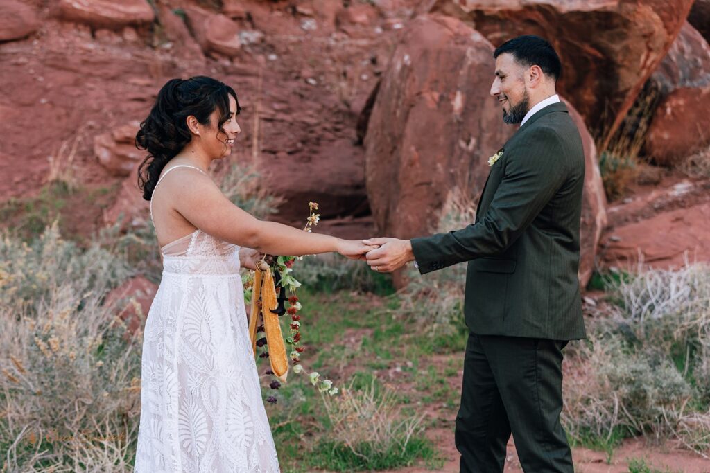 candid bride and groom first look in a red rock desert in moab