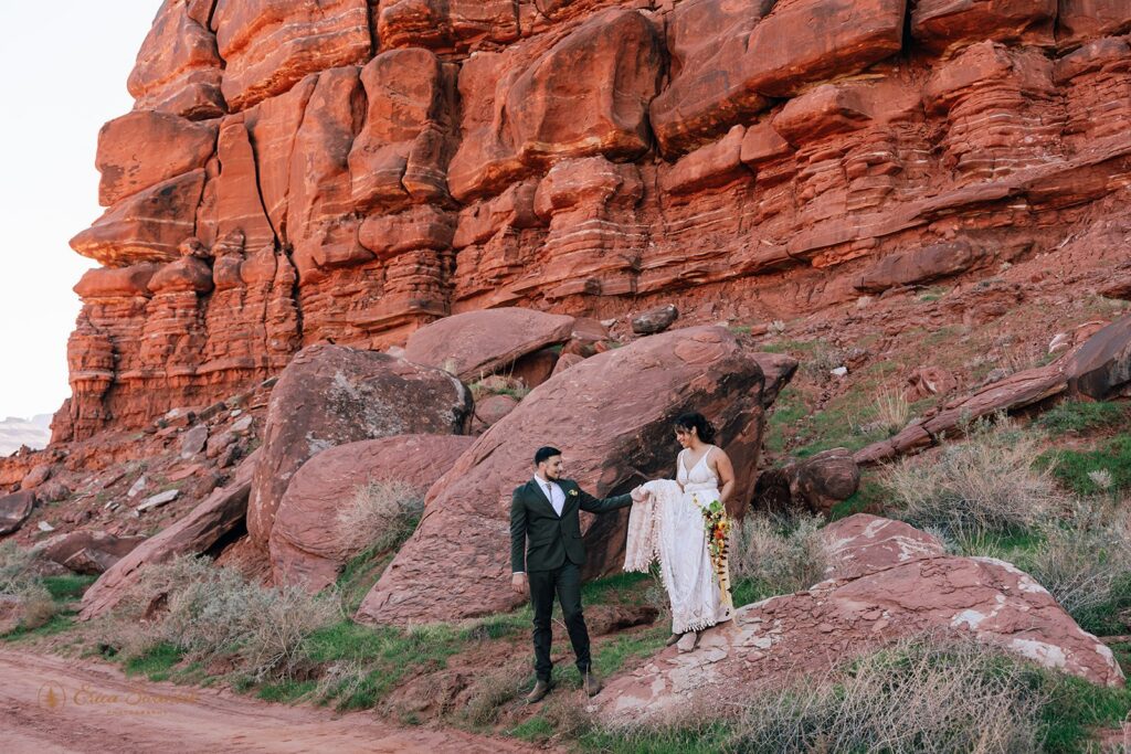loving bride and groom surrounded by red rock landscapes during their moab elopement