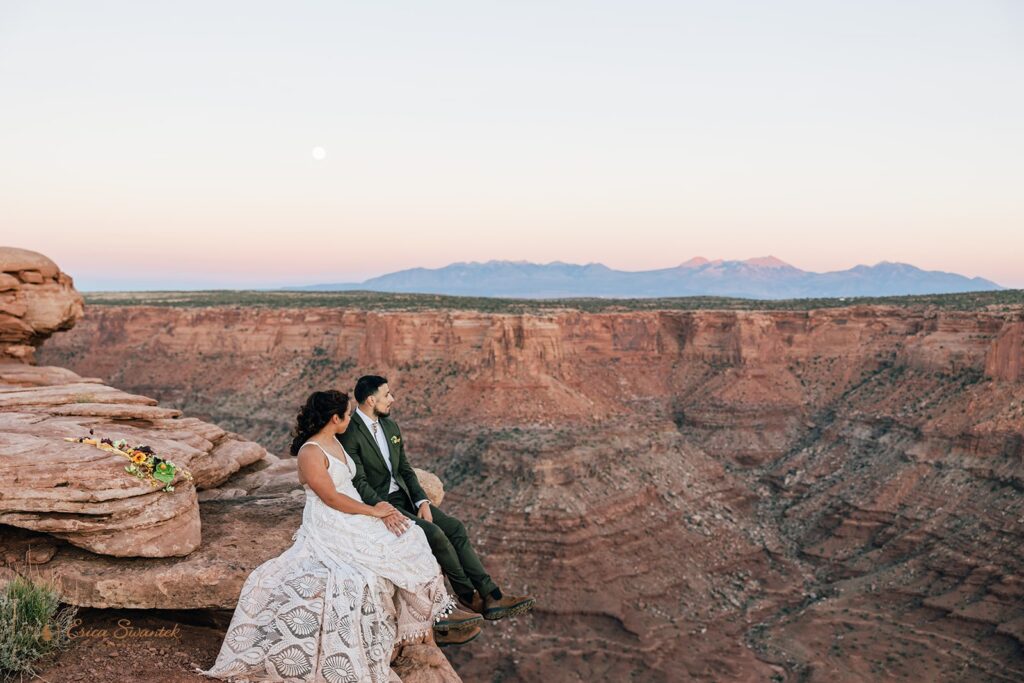 bride and groom surrounded by red rock landscapes at marlboro point in moab