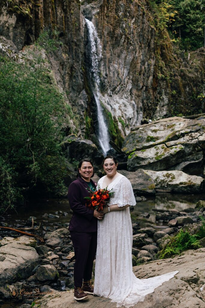 sweet elopement couple in front of a waterfall in pnw