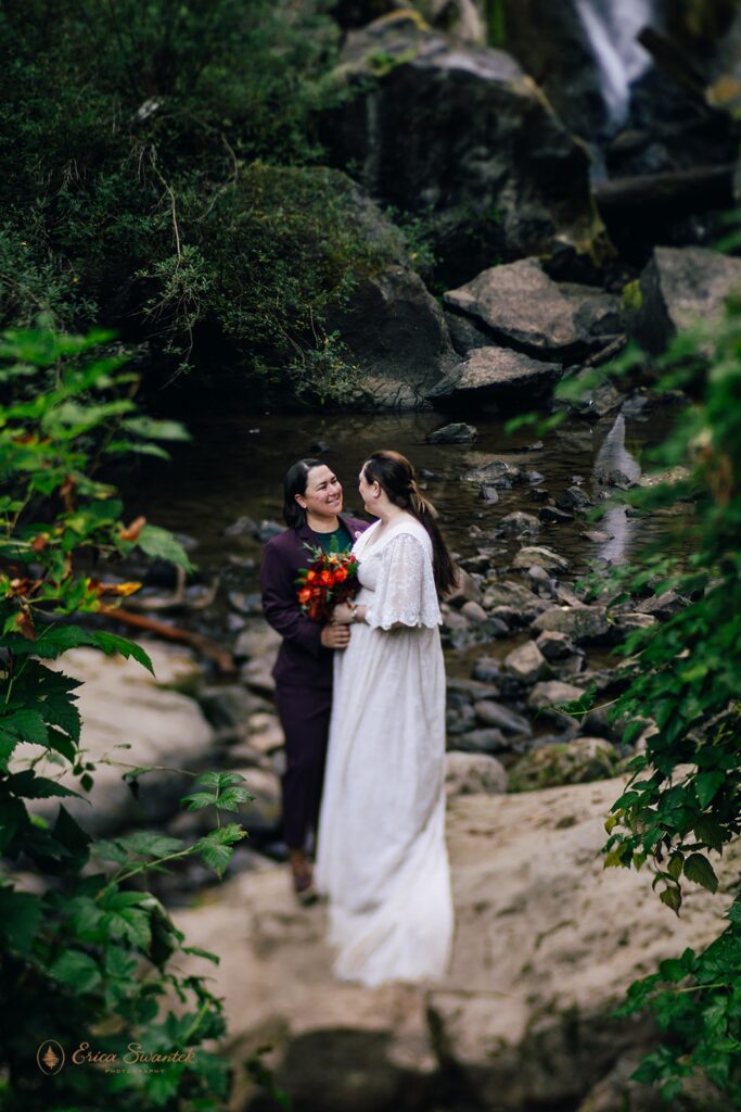 sweet elopement couple in front of a waterfall in pnw