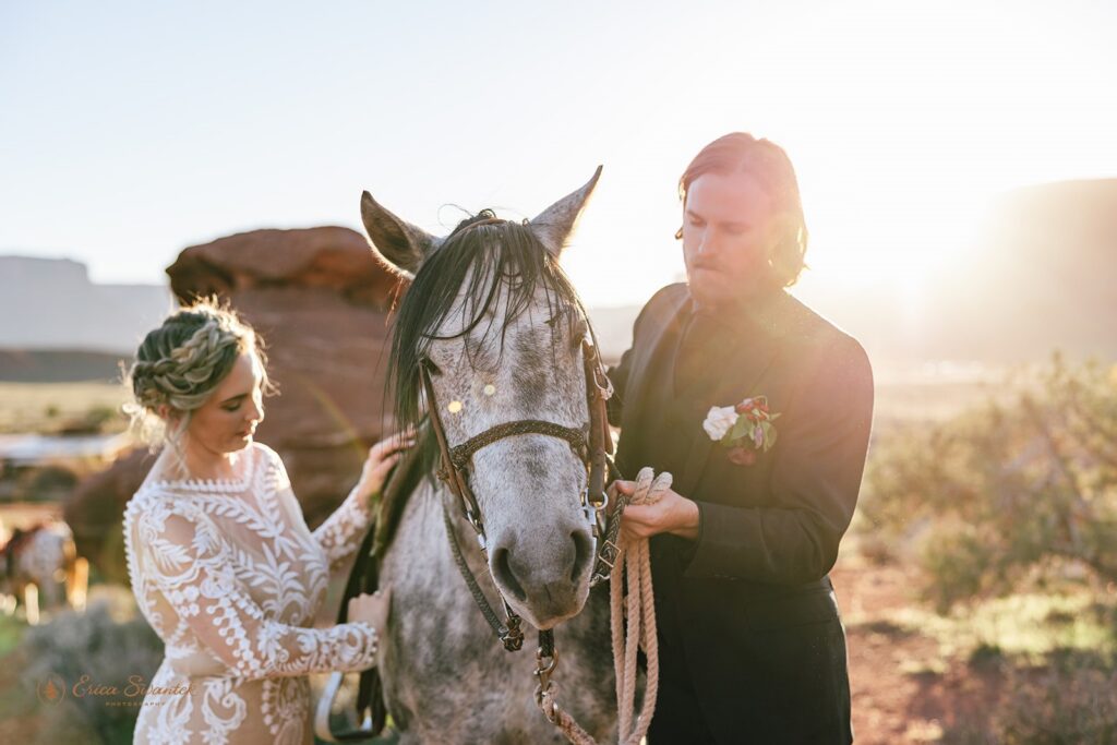 elopement couple posing with their horse during their western elopement in moab