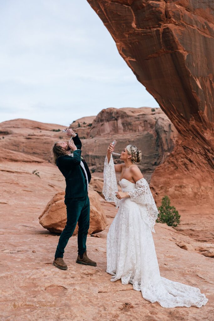 bride and groom drinking champagne bong