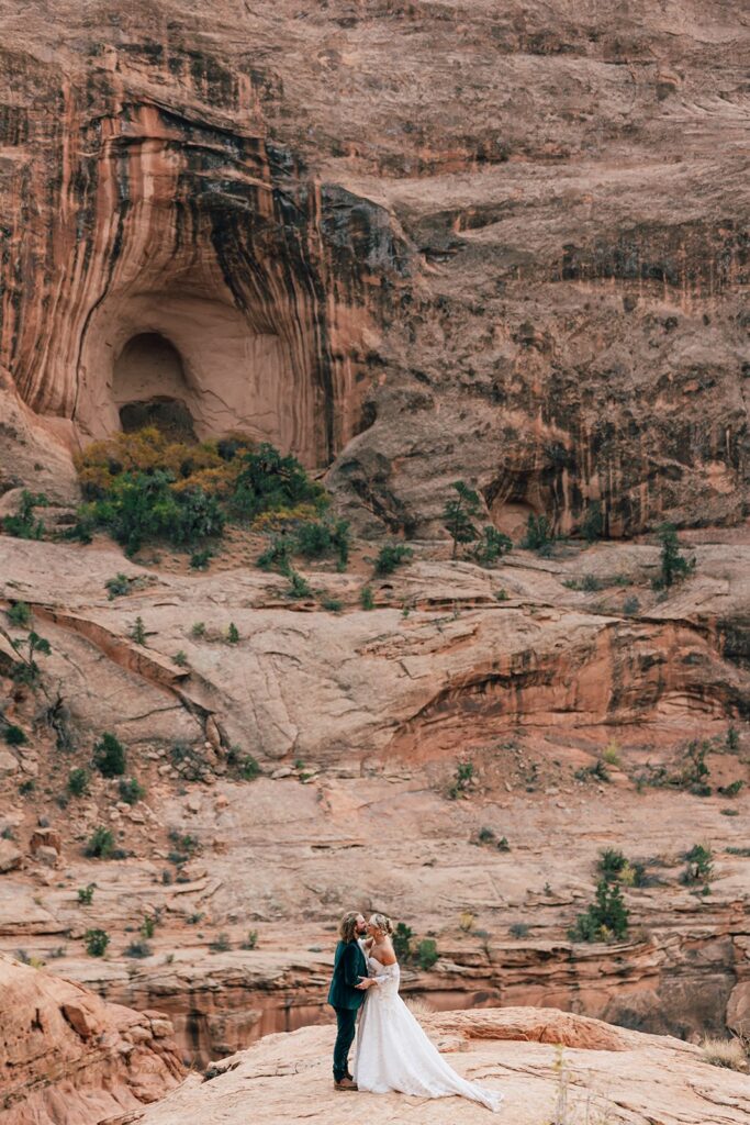 candid moab desert elopement ceremony at corona arch