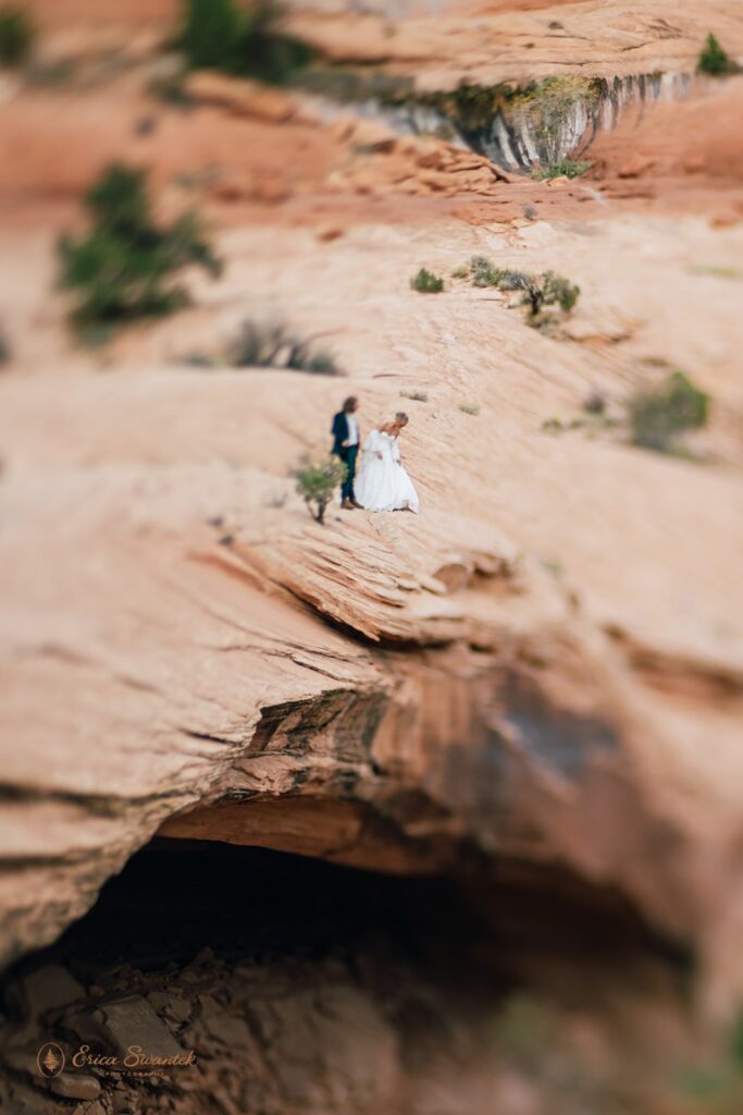 adventurous elopement couple hiking the red rock cliffs in moab during their skydiving wedding day