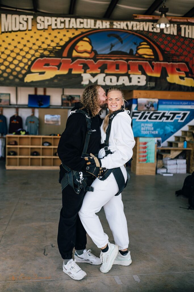 bride and groom putting on the gear for their skydiving wedding experience
