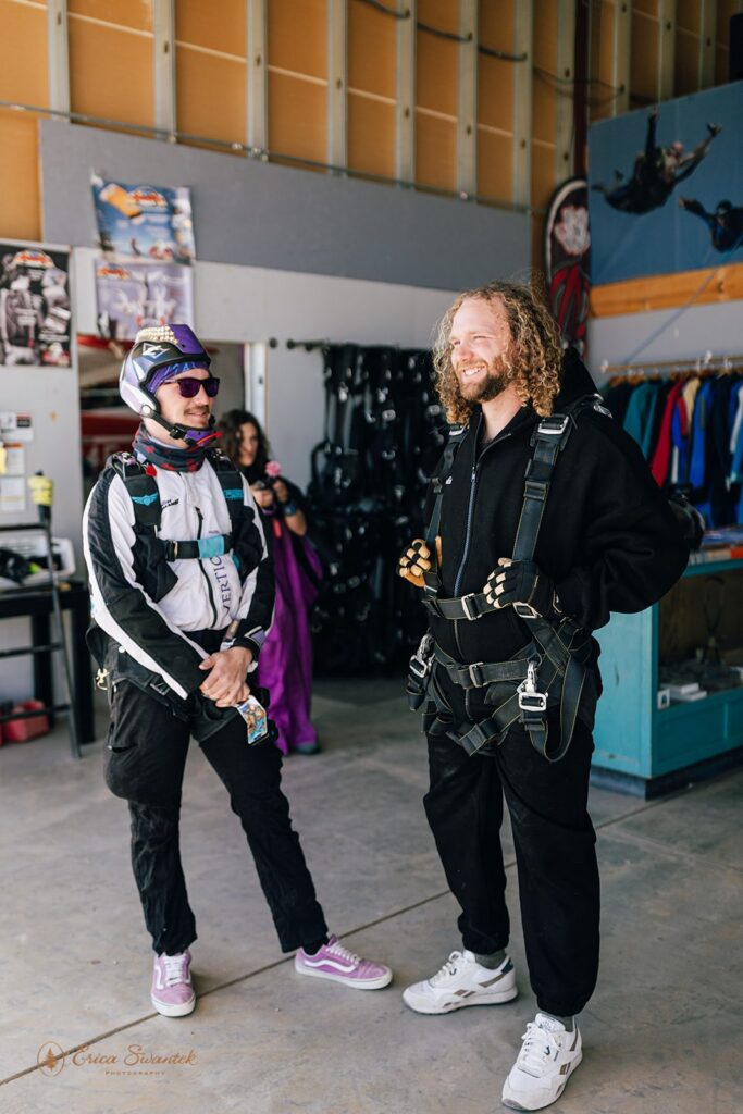 bride and groom putting on the gear for their skydiving wedding experience