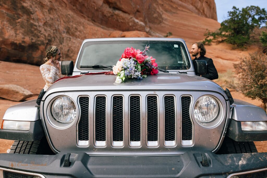 bride and groom at their jeep