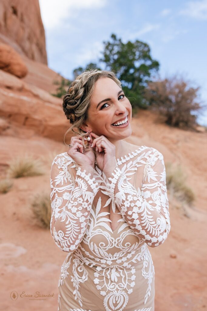 bride in front of red rock formations during western elopement in moab